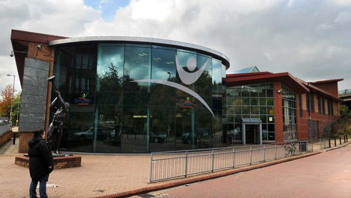 Exterior of Glasgow Club Springburn with glass panel entrance and logo 