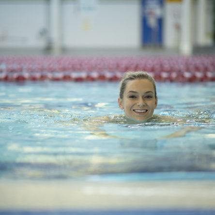 A person doing breast stroke in swimming pool