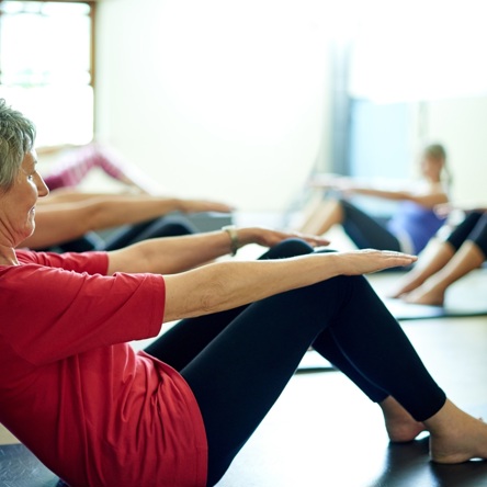 A group of adults doing crunches during a core stability class