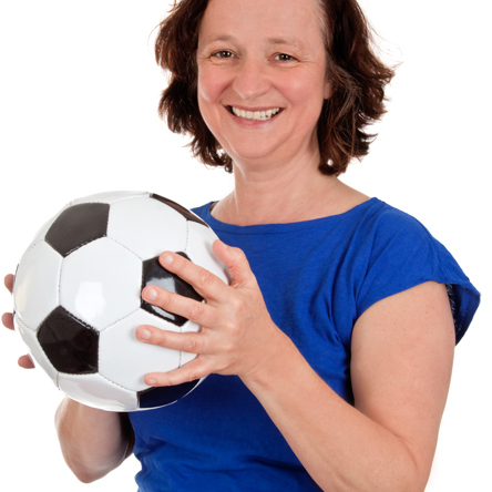 A person in blue top holding a football