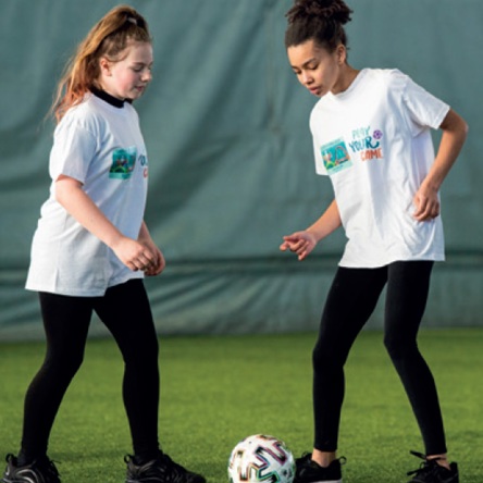 Two footballers kicking ball