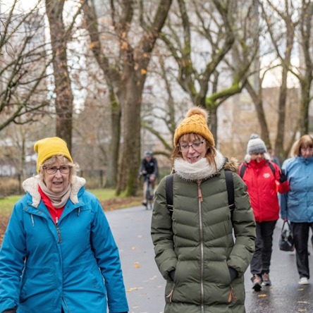 A group of people walking together in a park