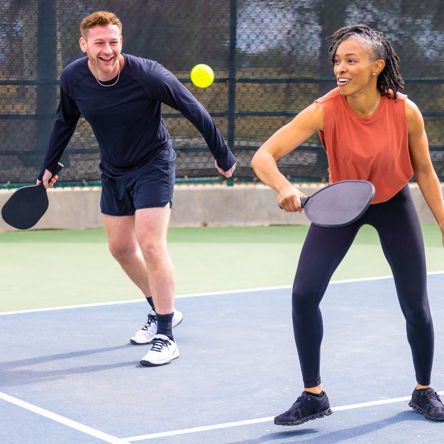 Two people playing pickleball