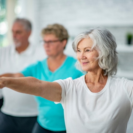 A group of adults taking part in Tai Chi class