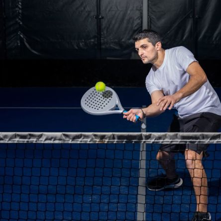 A padel tennis player practicing their game