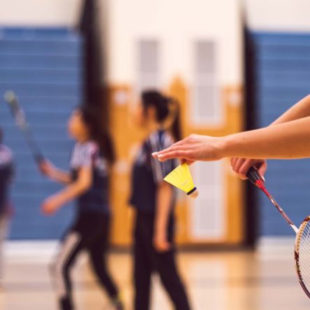 Young people playing badminton
