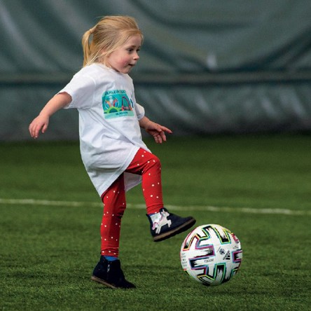 A child taking part in mini kickers