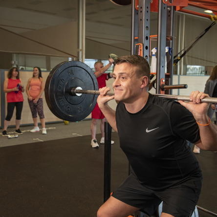 A person doing a squat during Lift It class. 