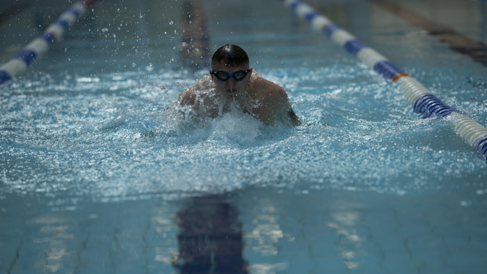 A person doing breast stroke in swimming pool