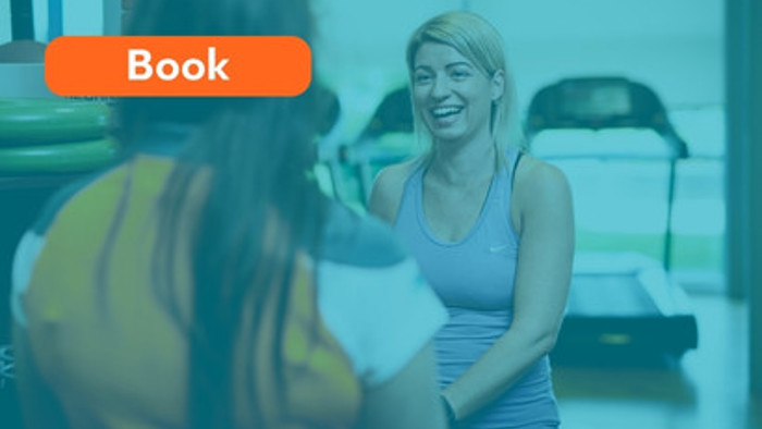 A gym member and a trainer in conversation